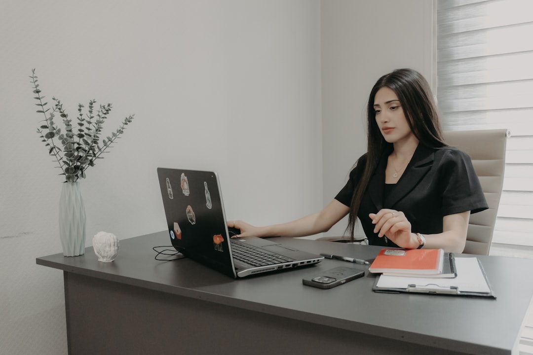 Woman working on a laptop at an office desk
