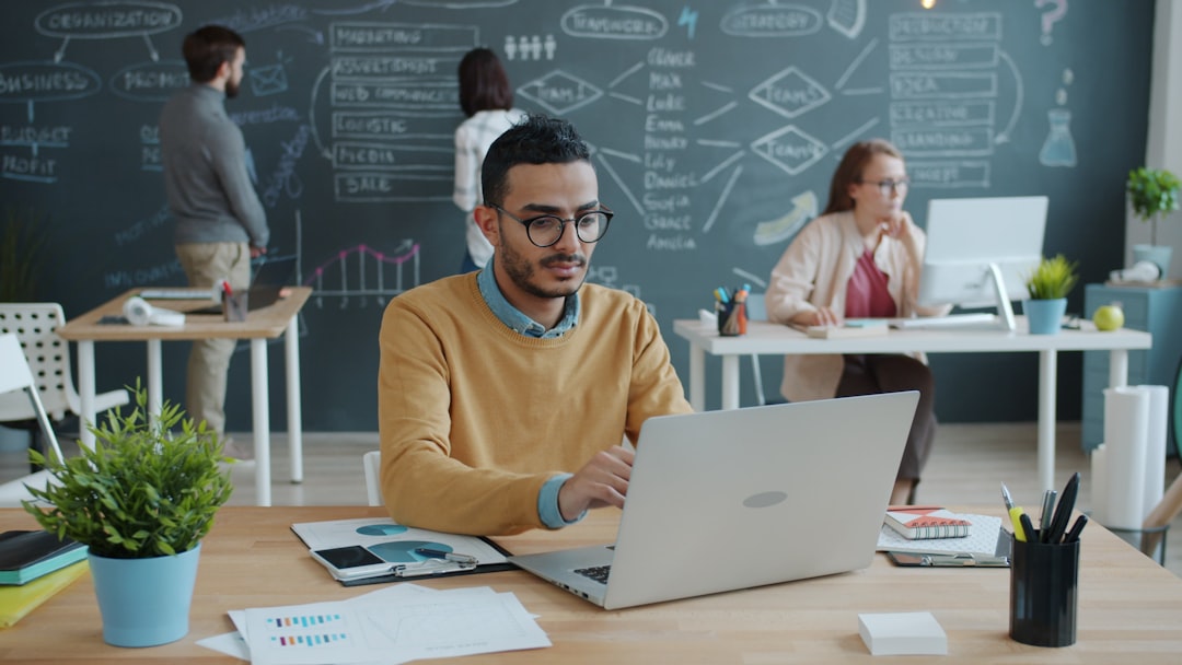 People working in a modern office with a chalkboard