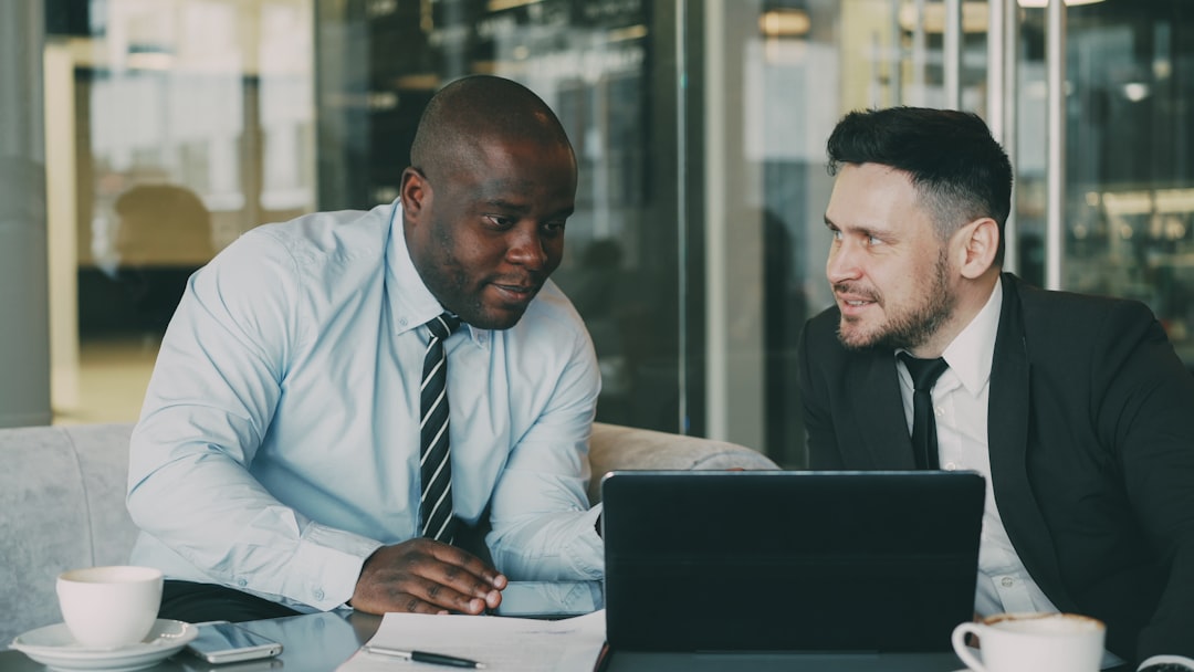 Two businessmen discussing documents at a table