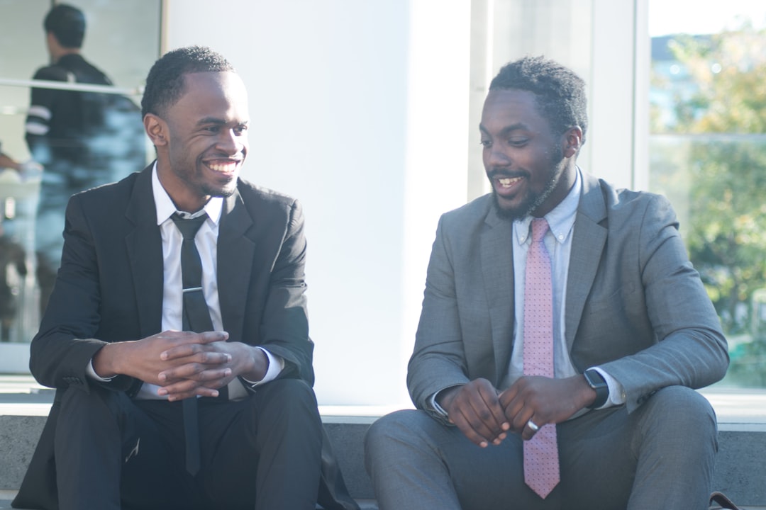 a couple of men sitting next to each other